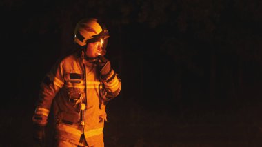 Gece kaza mahallinde üniformalı itfaiyeci.