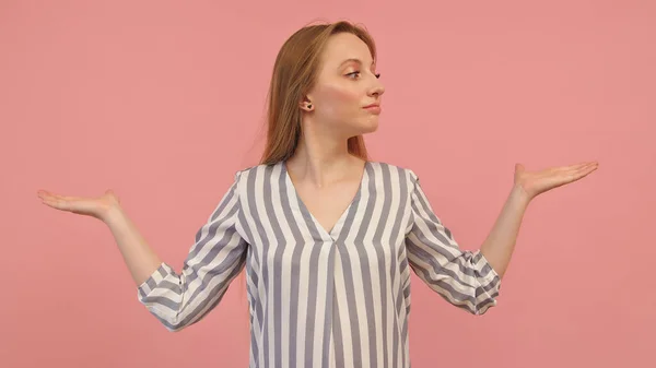 Young caucasian woman with outstretched hands like holding something isolated on pink background. Copy space — Stock Photo, Image