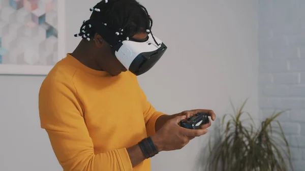 Virtual reality, African black man with VR goggles using remote controller and playing games — стоковое фото