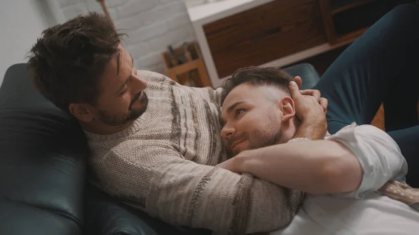 Passionate hug between homosexual partners. Man soothing his partner