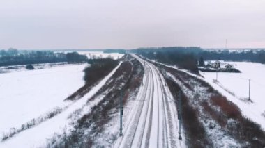 Aerial view of empty railway covered in snow