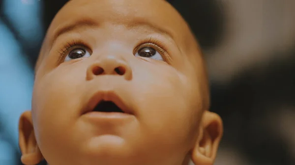 Portrait of adorable curious multiracial dark skin baby looking up. — Stock Photo, Image