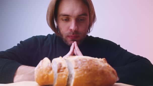 Young caucasian man on low carb diet staring into the loaf of bread — Stock Video