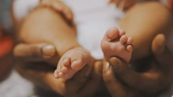 Padre negro jugando con pies de bebé. De cerca. — Foto de Stock