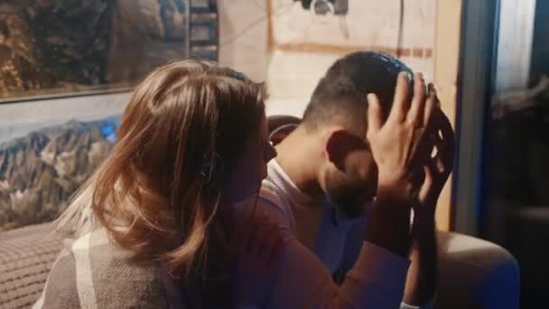 Young woman calming her boyfriend witnessing ambulance taking his family member — Stock Video