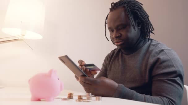 Интернет-магазины, Молодой афроамериканец черный мужчина, использующий смартфон для онлайн-покупок и оплаты кредитной картой — стоковое видео