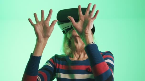 Mujer mayor con gafas de Realidad Virtual tocando el aire — Vídeo de stock