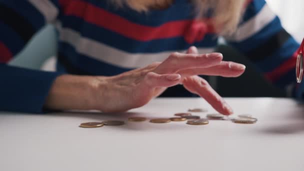 절망적 인 노인 연금 수급자가 탁자 위에 놓인 작은 양의 동전을 보고 있습니다 — 비디오