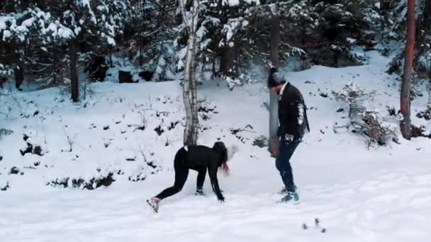 Jeune couple heureux s'amuser et se jeter de la neige pendant l'hiver — Video