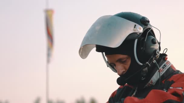 Piloto vestindo roupas e equipamentos de segurança, windsock no fundo — Vídeo de Stock