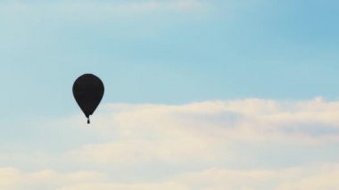 Aerial view of a hot air balloon with beautiful blue cloudy sky in the background