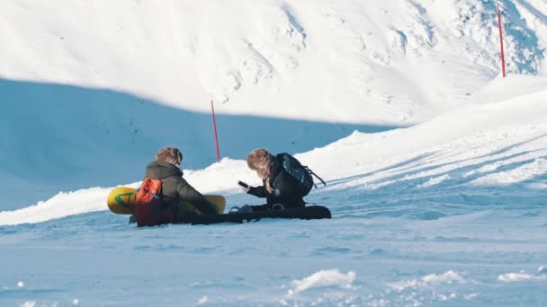 Footage Of Two Skiers Sitting On A Snow-Covered Mountain - Skiers Taking A Break — 비디오