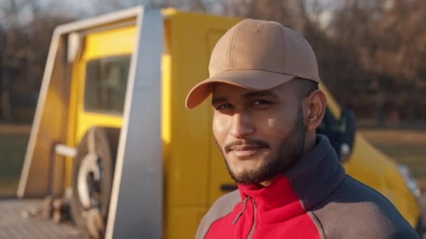 Giovane lavoratore che indossa berretto sorridente alla macchina fotografica Concetto di meccanica automobilistica — Video Stock