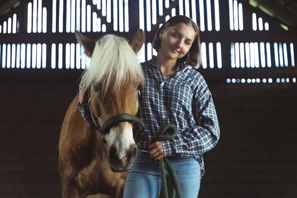 Horse Owner Standing With A Light Brown Horse In The Stable - Holding Its Rope