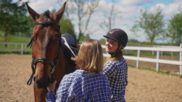 Two young women in plaid shirts prepare a horse — Stock Photo, Image