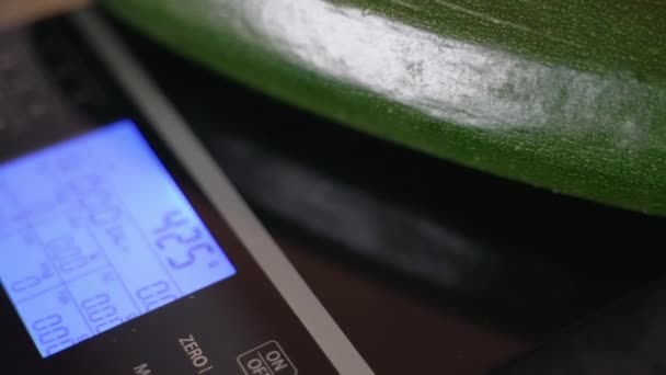 Красивий зелений огірок в електронному масштабі з дисплеєм, освітленим штучним світлом — стокове відео