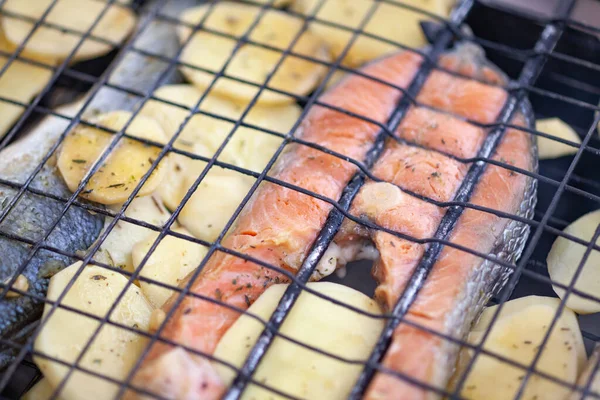 Trout and potatoes on a grill