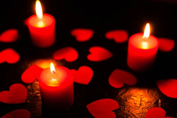 Black background with candles and hearts on Valentines Day — Stock Photo, Image