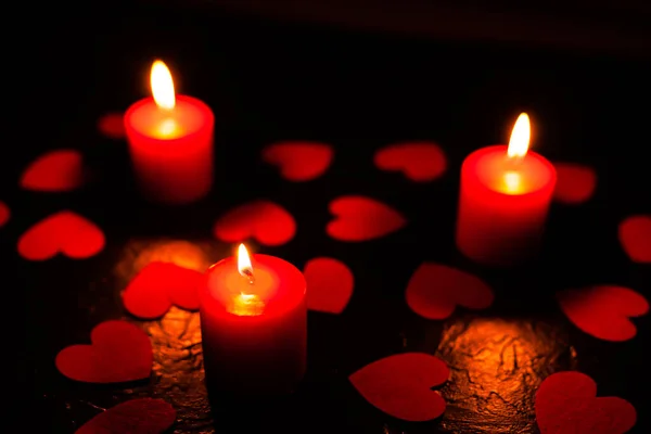 Black background with candles and hearts on Valentines Day — Stock Photo, Image