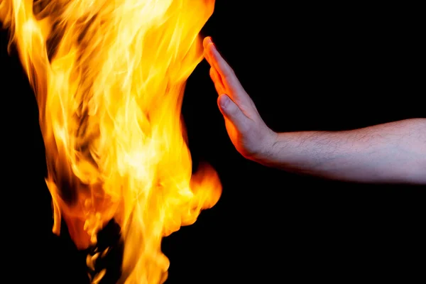 Human hand and burning flame, use as a poster — Stock Photo, Image