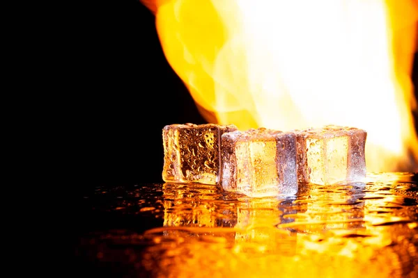 three ice cubes against the background of fire, fire and ice, place under the text