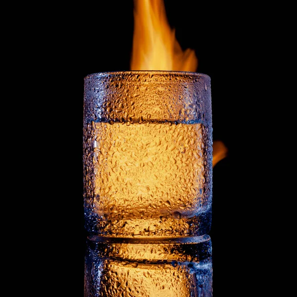 Sweated glass of vodka on fire, copy space — Stock Photo, Image