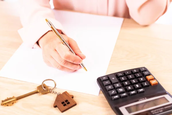 signing a home mortgage agreement, a woman signs a mortgage agreement, a close-up