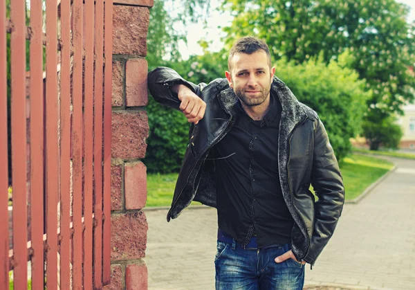 Portrait of the brutal young man in a leather jacket — Stock Photo, Image