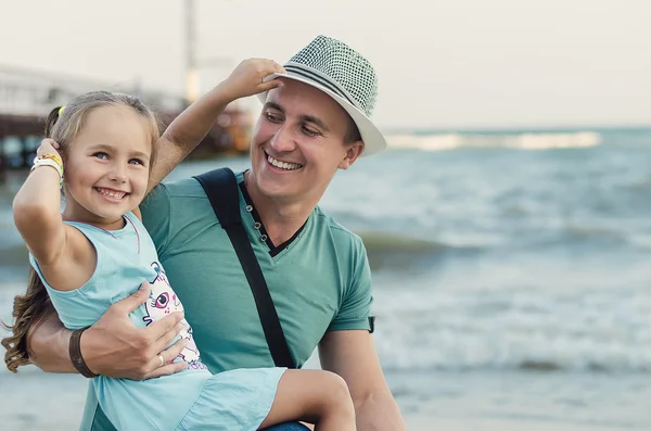 Happy father and his adorable little daughter smiling