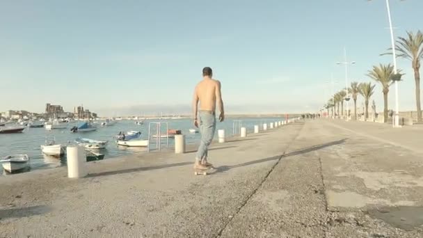 Jonge Man Draagt Blauwe Jeans Skates Blootsvoets Shirtloos Pier Middag — Stockvideo