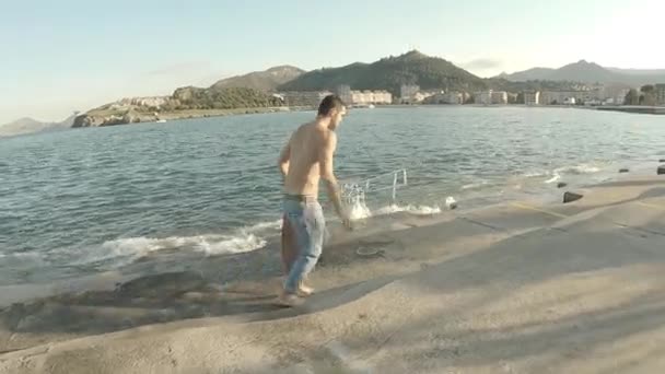 Jeune Homme Jeans Bleu Skate Pieds Nus Torse Sur Jetée — Video