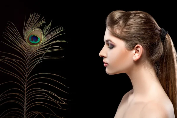 Girl with bright  makeup and peacock feathe — Stock Photo, Image