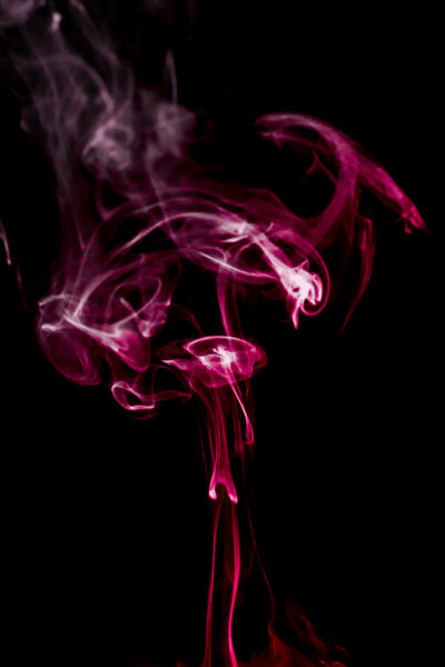 Curls of red smoke on a black background