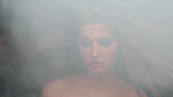 Girl model smoke blowing smoke and throws up hair biting her lip — Stock Video