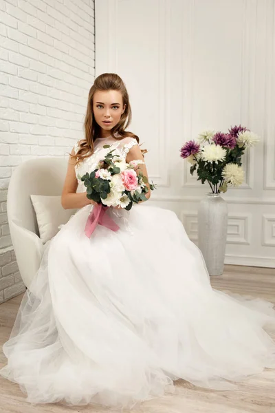 Beautiful tender young bride with flower bouquet — Stock Photo, Image