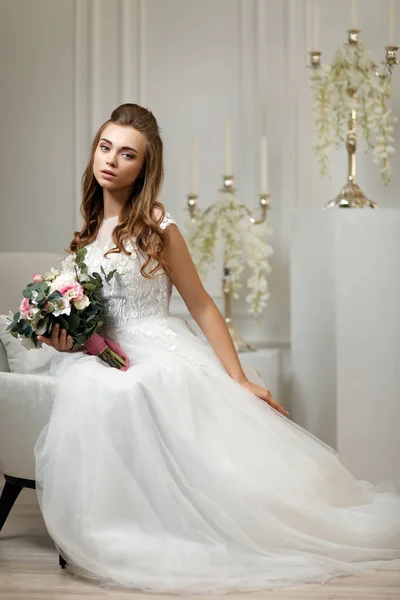 Beautiful tender young bride with flower bouquet — Stock Photo, Image