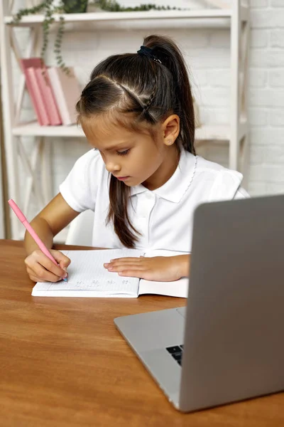 Malé dítě dívka pomocí notebooku pro online lekci doma — Stock fotografie