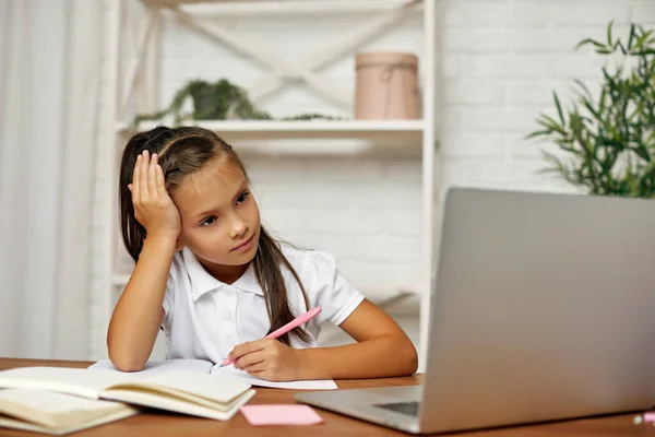 little child girl using laptop for studying online