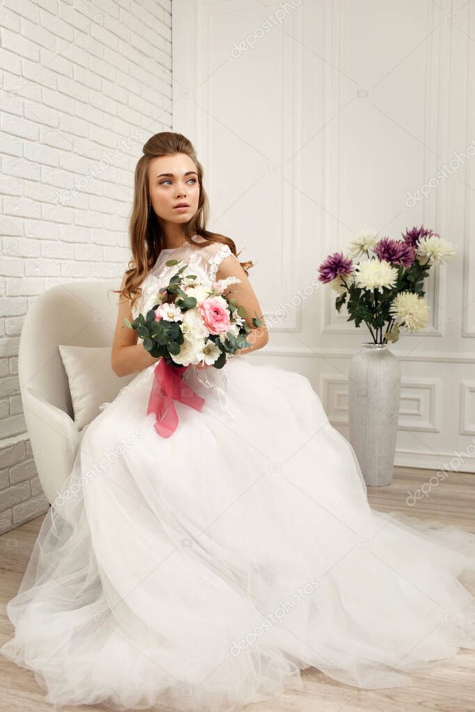 beautiful tender young bride with flower bouquet