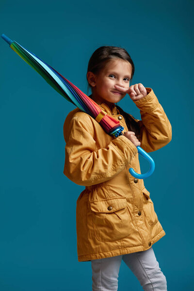 cute child girl with multicolored umbrella