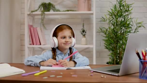 Little child girl using laptop computer for studying online e-learning system. — Stock Video