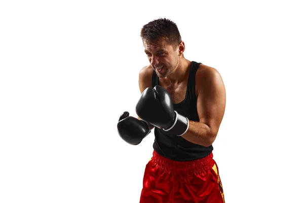 Sporty man in black boxing gloves punching — Stock Photo, Image