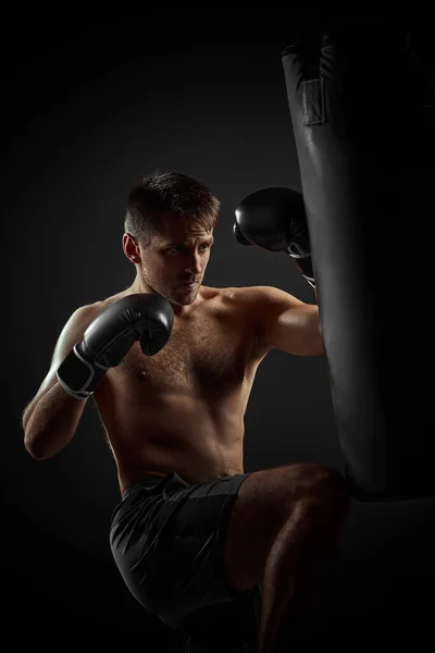 Boxer punching in boxing bag — Stock Photo, Image