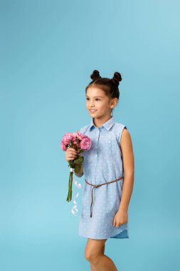 little girl holding bouquet of roses