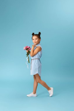 Küçük kız pembe gül buketi tutuyor