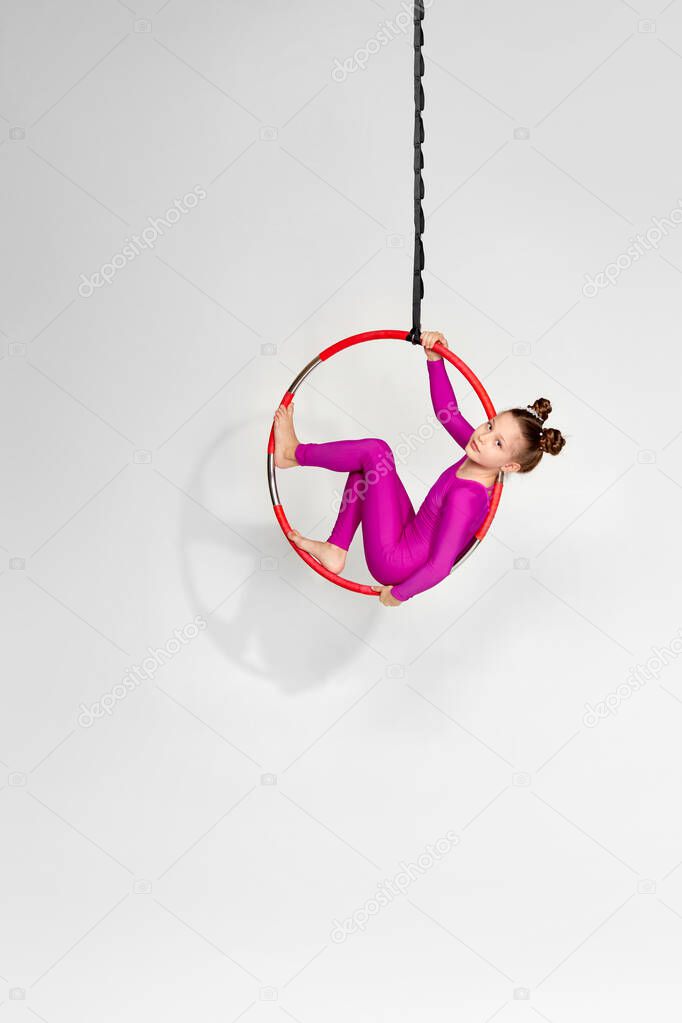 Girl gymnast shows an acrobatic performance