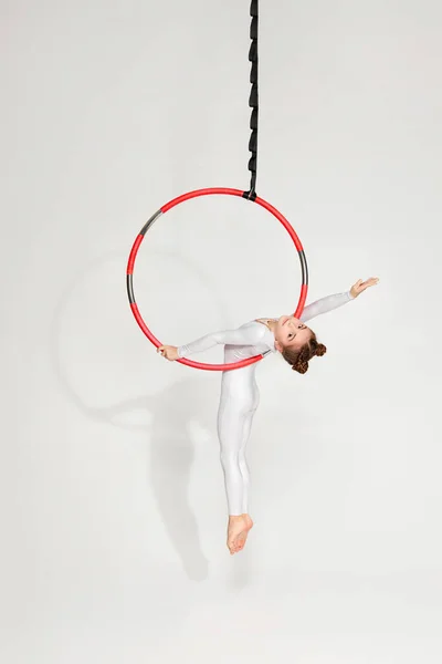 Girl gymnast shows an acrobatic performance