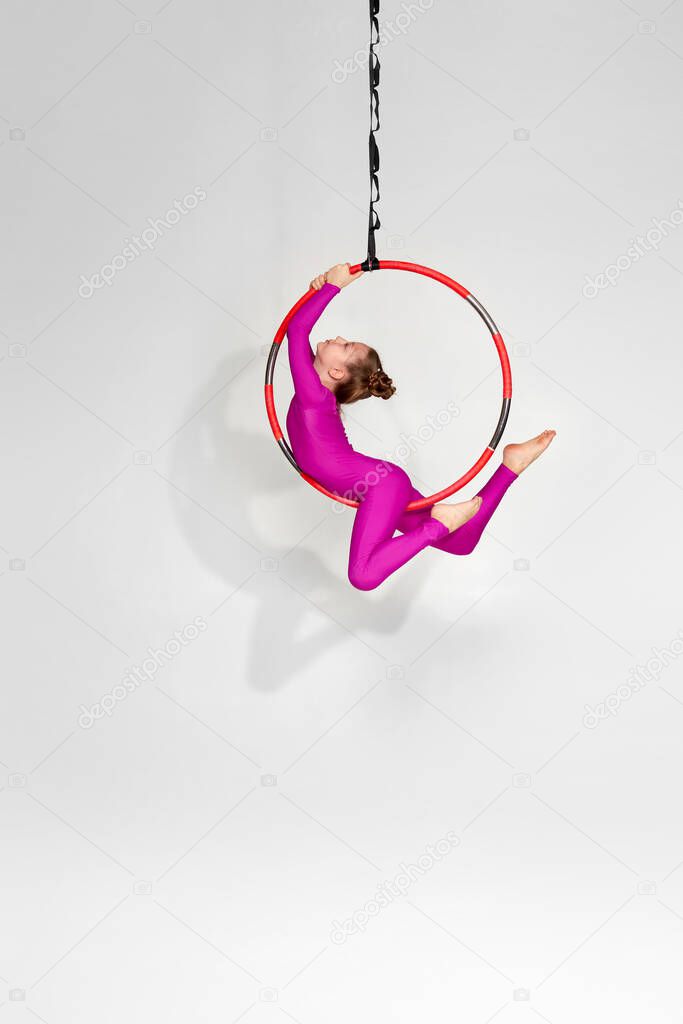 Girl gymnast shows an acrobatic performance
