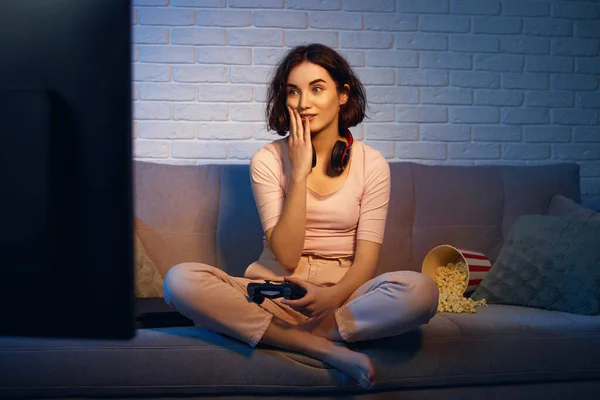 involved gamer girl playing video games on the console