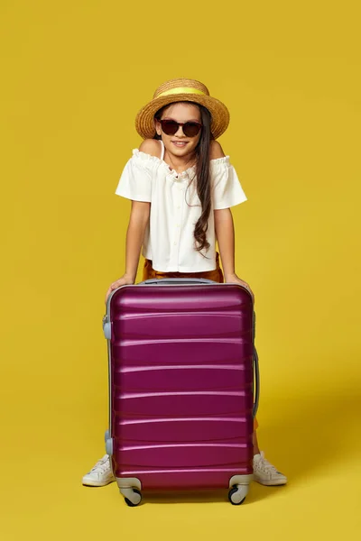 Happy little girl dziecko w kapeluszu z różową walizką — Zdjęcie stockowe
